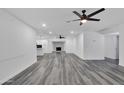 Open concept living room with hardwood floors and fireplace at 1873 E Ellis Dr, Tempe, AZ 85282