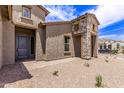 House exterior with stone accents and a gray door at 20755 W San Miguel Ave, Buckeye, AZ 85396
