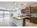 Spacious kitchen with island, stainless steel appliances, and granite countertops at 5557 W Buckskin Trl, Phoenix, AZ 85083