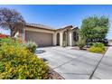 Single story home with a two car garage and nicely landscaped front yard at 5557 W Buckskin Trl, Phoenix, AZ 85083