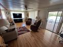 Bright living room featuring hardwood floors, comfy seating, and access to a deck at 9501 E Broadway Rd # 221, Mesa, AZ 85208