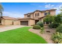 Two-story house with a landscaped yard and a two-car garage at 9632 E Tangerine Rd, Florence, AZ 85132