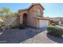 Two-story home with attached garage and neatly landscaped front yard at 17511 N Kimberly Way, Surprise, AZ 85374