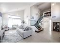Open-concept living room with high ceilings, and a modern staircase at 17511 N Kimberly Way, Surprise, AZ 85374