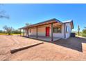 Ranch style home with covered porch and red door at 30240 N 60Th St, Cave Creek, AZ 85331