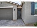 Modern home exterior with gray stucco, paver walkway, and dark gray door at 1859 N Westfall Ln, Casa Grande, AZ 85122