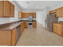 Kitchen features light wood cabinets, stainless steel appliances, and tile flooring at 11168 E Lost Canyon Ct, Gold Canyon, AZ 85118