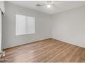 Bright bedroom with wood-look floors and window blinds at 11168 E Lost Canyon Ct, Gold Canyon, AZ 85118