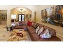 Spacious living room with a large leather sectional sofa and large artwork at 10220 E Cochise Dr, Scottsdale, AZ 85258