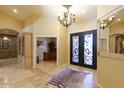 Elegant entryway with a chandelier, hardwood floors, and decorative rug at 10220 E Cochise Dr, Scottsdale, AZ 85258