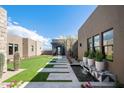 Modern home exterior with landscaped courtyard and water feature at 24046 N 126Th Pl, Scottsdale, AZ 85255