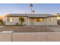 Front exterior of a single-story home with a low wall and gravel landscaping at 2226 N 61St Ave, Phoenix, AZ 85035