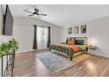 Spacious main bedroom with hardwood floors, a large bed, and stylish decor at 3406 E Libby St, Phoenix, AZ 85032