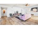 Living room with hardwood floors, pink sofa, and mid-century modern style at 8634 E Monterosa Ave, Scottsdale, AZ 85251