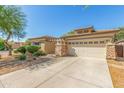 One-story home with a two-car garage and desert landscaping at 13820 W Cheery Lynn Rd, Avondale, AZ 85392