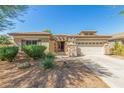 One-story home with a two-car garage and desert landscaping at 13820 W Cheery Lynn Rd, Avondale, AZ 85392