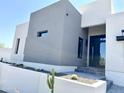 Modern home's front entrance with gray and white exterior at 27222 N 64Th Dr, Phoenix, AZ 85083