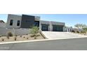 Modern home exterior with two-car garage and landscaping at 27222 N 64Th Dr, Phoenix, AZ 85083