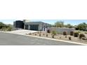 Modern home exterior showcasing landscaping and driveway at 27222 N 64Th Dr, Phoenix, AZ 85083