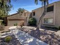 Attractive exterior of a two-story condo with a walkway and landscaping at 7417 N Via Camello Del Norte -- # 160, Scottsdale, AZ 85258