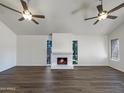 Spacious living room featuring a fireplace and dark laminate flooring at 7417 N Via Camello Del Norte -- # 160, Scottsdale, AZ 85258