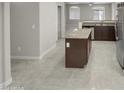 Open kitchen with an island, granite countertops, and tile flooring at 2150 W Alameda Rd # 1250, Phoenix, AZ 85085
