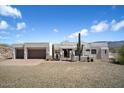 Two-story stucco home with a three-car garage and desert landscaping at 43908 N 10Th St, New River, AZ 85087