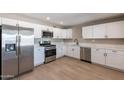 Modern kitchen featuring stainless steel appliances and white shaker cabinets at 1018 S Lola Ln, Tempe, AZ 85281