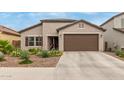 Single-story home with desert landscaping and a two-car garage at 6709 W Pleasant Oak Ct, Florence, AZ 85132