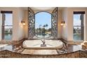 Luxurious bathroom with a large bathtub and scenic water views at 1402 E Coral Cove Dr, Gilbert, AZ 85234