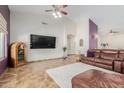 Living room featuring a large TV, leather furniture, and tile floors at 44423 N 16Th St, New River, AZ 85087