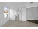 Bright bedroom with neutral walls, carpet flooring, and access to bathroom at 6447 W Escuda Rd, Glendale, AZ 85308
