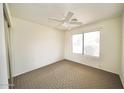 Bedroom with ceiling fan and window at 14300 W Bell Rd # 444, Surprise, AZ 85374