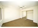 Bright bedroom with ceiling fan and mirrored closet at 14300 W Bell Rd # 444, Surprise, AZ 85374
