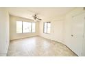 Living room with tile floor and large window at 14300 W Bell Rd # 444, Surprise, AZ 85374