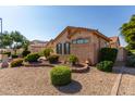 One-story house with landscaped front yard, featuring desert landscaping and stone accents at 17916 W Addie Ln, Surprise, AZ 85374