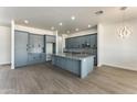 Modern kitchen with gray cabinets and granite island at 3368 W Judd Rd, San Tan Valley, AZ 85144
