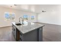 Modern kitchen with gray island and granite countertops at 3368 W Judd Rd, San Tan Valley, AZ 85144