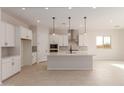 Modern kitchen with white cabinets and island at 23964 N 171St Ln, Surprise, AZ 85387