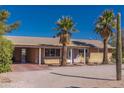 House exterior featuring carport and palm trees in front at 350 Ocotillo Dr, Wickenburg, AZ 85390