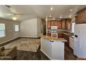 Open concept kitchen with island and adjacent living area at 650 N Hawes Rd # 3803, Mesa, AZ 85207