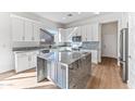 Modern kitchen with white cabinets, large island, and granite countertops at 5525 E Dusty Wren Dr, Cave Creek, AZ 85331