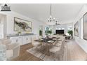 Elegant dining room with modern light fixture and views to the living room at 5525 E Dusty Wren Dr, Cave Creek, AZ 85331