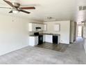 Open kitchen with white cabinets and dark appliances at 137 E Douglas Ave, Coolidge, AZ 85128