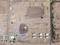 Aerial view of a large equestrian property with multiple buildings and paddocks at 48940 W Long Rifle Rd, Aguila, AZ 85320