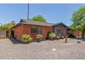 Brick ranch home with side yard landscaping at 6609 N 41St Dr, Phoenix, AZ 85019