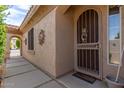Front door entry with decorative metal gate and welcome mat at 2074 E Hulet Pl, Chandler, AZ 85225