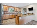 Modern kitchen with wood cabinets, granite counters, and stainless steel appliances at 3744 W Westcott Dr, Glendale, AZ 85308