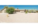 Well-maintained front yard with gravel and mature shrubs at 8702 E Boise St, Mesa, AZ 85207