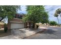 Two-story house with attached garage, landscaping, and neighborhood view at 6349 W Valencia Dr, Laveen, AZ 85339